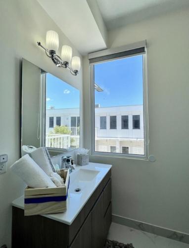 a bathroom with a sink and a large window at Modern Townhouse with terrace! in Homestead