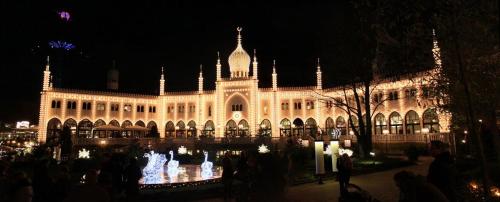 a large building with a fountain in front of it at night at ApartmentInCopenhagen Apartment 1484 in Copenhagen