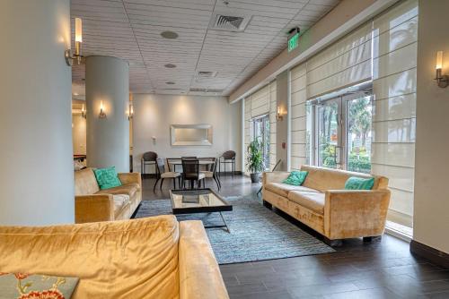 a living room with couches and a table at Hollywood Condos in Hollywood