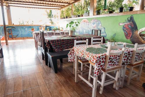 a restaurant with a table and chairs in a room at Morango das Palmas in Praia de Palmas
