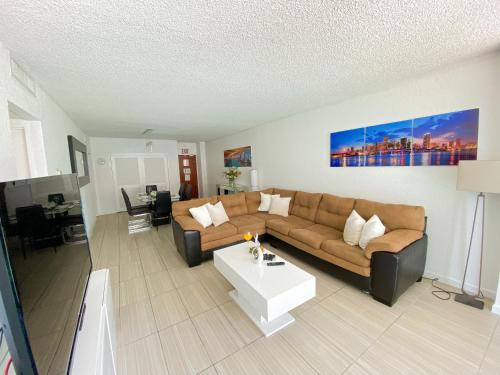 a living room with a couch and a coffee table at Oceanfront Condo - Ocean Views, Pool, Gym Hollywood Beach in Hollywood