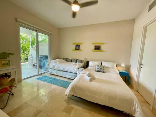 a bedroom with two beds and a sliding glass door at Next to Puntarena Beach Club! - Amazing Balcony - Sleeps 6 in Boca de Río Hato