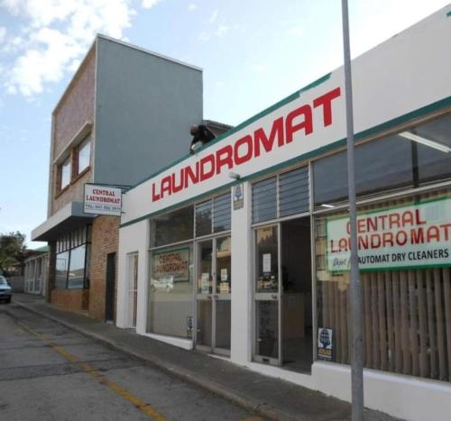 a store front with a sign that reads lumber mart at The Gallery Guest House in Port Elizabeth