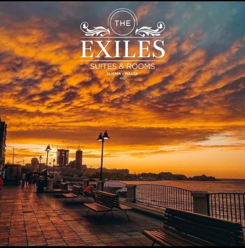 a sign that reads the eyelides suites and rooms with a sunset at The Exiles Hotel in Sliema
