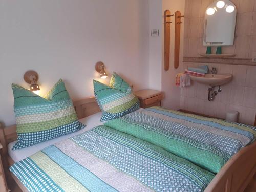 a small bedroom with a bed and a sink at Haus Widlbrand in Schönau am Königssee