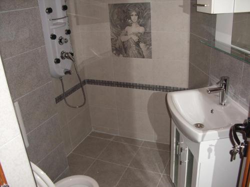 a bathroom with a shower and a sink at Family Hotel Malibu in Chernomorets