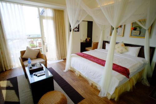 a bedroom with a bed with a canopy at Chiu Chunt Dint B&B in Jiufen