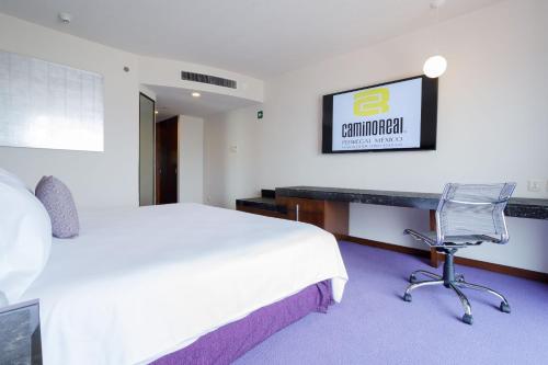 a hotel room with a bed and a desk at Camino Real Pedregal Mexico in Mexico City