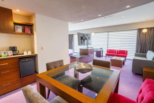 a living room with a dining table and a living room at Camino Real Pedregal Mexico in Mexico City