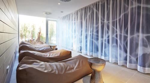 a room with three couches and a window at JS Palma Stay - Adults Only in Can Pastilla
