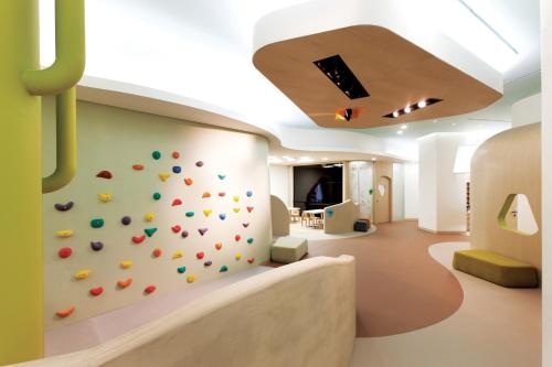 a gym with a climbing wall in a building at The Shilla Jeju in Seogwipo