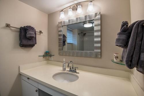 a bathroom with a sink and a mirror at Kailua Village 5th floor - View of Kailua Bay KV506 in Kailua-Kona