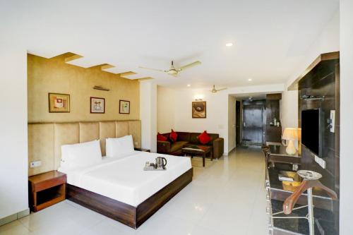 a bedroom with a bed and a living room at Townhouse 517 La Sapphire Near Delhi Airport in New Delhi