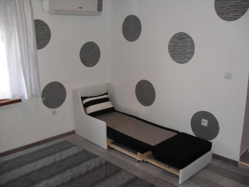 a bedroom with a bed and a wall with circles at Family Hotel Malibu in Chernomorets