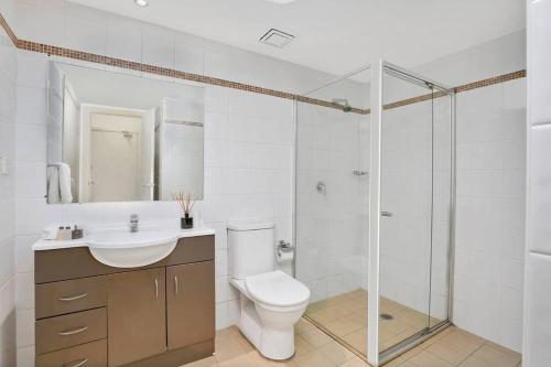 a bathroom with a toilet and a sink and a shower at BAR09- 1 bedroom unit In Heart of Cremorne in Sydney