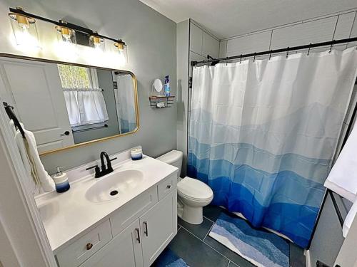 a bathroom with a sink and a toilet and a shower at Bigfoot Bungalow in Logan