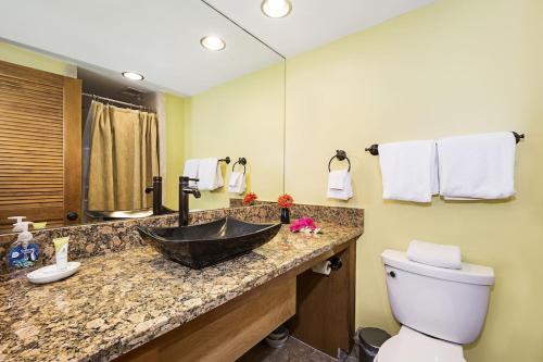 a bathroom with a sink and a toilet at Ocean Front Condo SV4207 in Kailua-Kona
