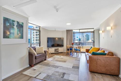 a living room with a couch and a tv at Apartment on Top of the Park in Sydney