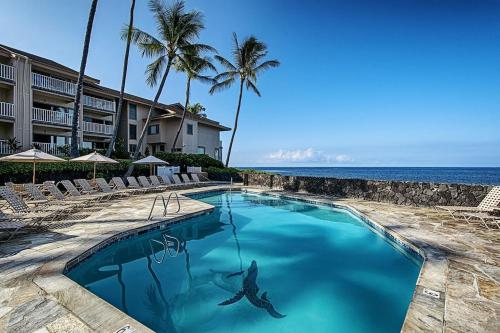 a swimming pool with a shark in the water at Ocean Front Condo SV4207 in Kailua-Kona