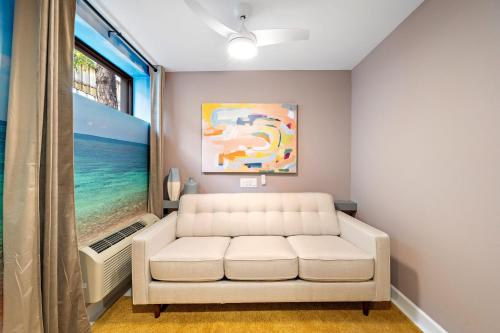 a living room with a white couch and a window at Wanderstay Boutique Hotel in Houston