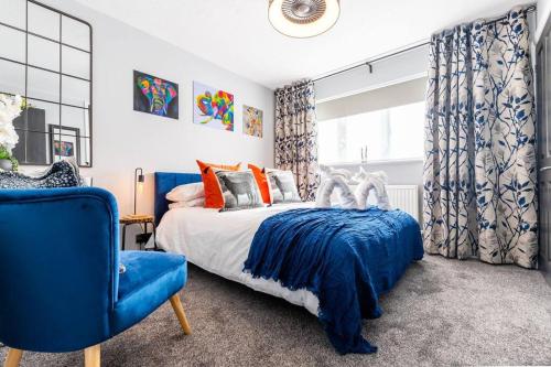 a bedroom with a blue bed and a blue chair at iStay Here Ltd - Luxury 1 Bed with Wifi, Sky, Parking - African Adventure in Aston End