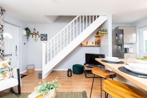 a kitchen and living room with white walls and a staircase at iStay Here Ltd - Luxury 1 Bed with Wifi, Sky, Parking - African Adventure in Aston End