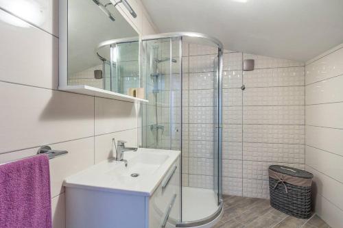 a bathroom with a sink and a glass shower at Villa Villetta Valtura in Ližnjan