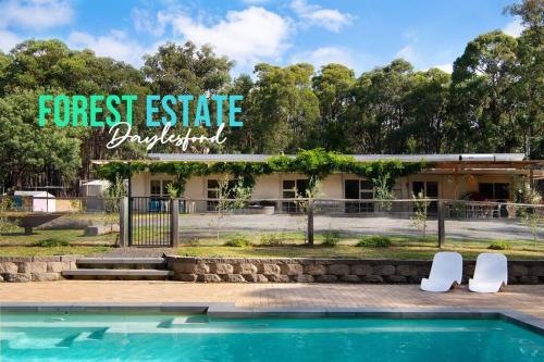 a house with a swimming pool and two white chairs at Forest Estate Daylesford 8 Bedrooms 18 pax Pool Sauna Weddings in Glenlyon