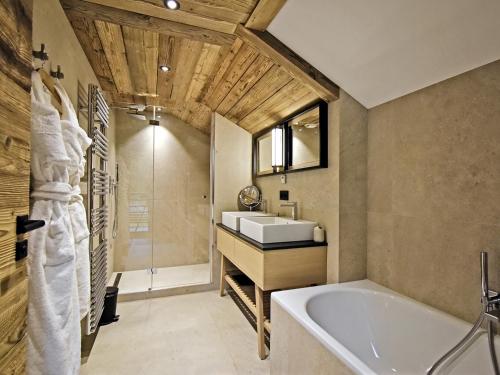 a bathroom with a bath tub and a sink at Chalet Méribel, 8 pièces, 13 personnes - FR-1-613-52 in Méribel