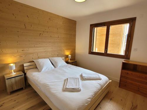 a bedroom with a bed with two trays on it at Appartement Les Gets, 2 pièces, 4 personnes - FR-1-598-143 in Les Gets