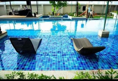 a swimming pool with two chairs in the middle of it at Cheryl queen studio in Cebu City