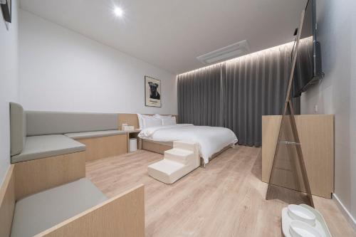 a hotel room with a bed and a chair at Aank Hotel Daejeon Yuseong 2nd in Daejeon