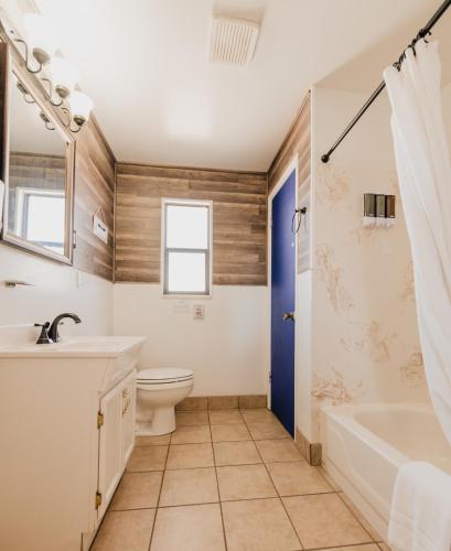 a bathroom with a tub and a toilet and a sink at 1 or 3 Bedroom Apartment with Full Kitchen in Page