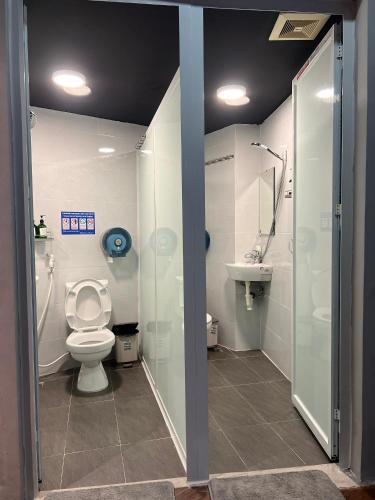 a bathroom with a toilet and a shower and a sink at Hanoi Luxury Hotel in Hanoi