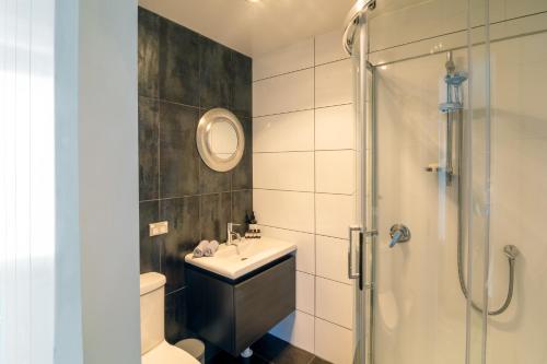 a bathroom with a sink and a shower at The Chefs Cottage in Waikanae