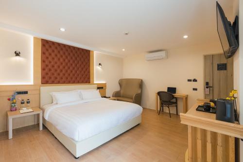 a hotel room with a bed and a television at Heaven Boutique Hotel in Bangkok