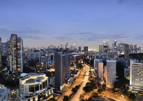 a view of a city at night with buildings at Holiday Inn Singapore Atrium by IHG in Singapore
