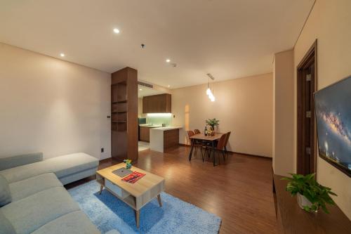 a living room with a couch and a table at DHTS Business Hotel & Apartment in Ho Chi Minh City
