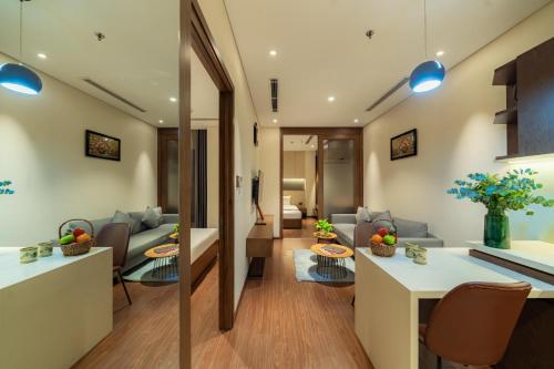 a living room with a couch and a table at DHTS Business Hotel & Apartment in Ho Chi Minh City