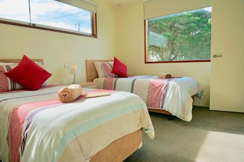 a bedroom with two beds with a dog laying on them at Beach Haven in Point Lonsdale
