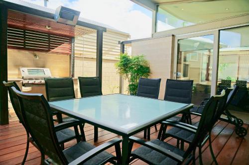 a blue table and chairs on a patio at Beach Haven in Point Lonsdale