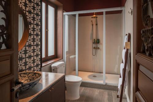 a bathroom with a shower and a toilet and a sink at neil niwas in Bangkok
