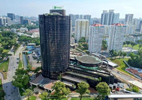 a tall building in the middle of a city at Holiday Inn Singapore Atrium by IHG in Singapore