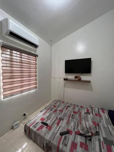a bedroom with a bed and a flat screen tv at Spacious & Cozy 3BR House w/WIFI 