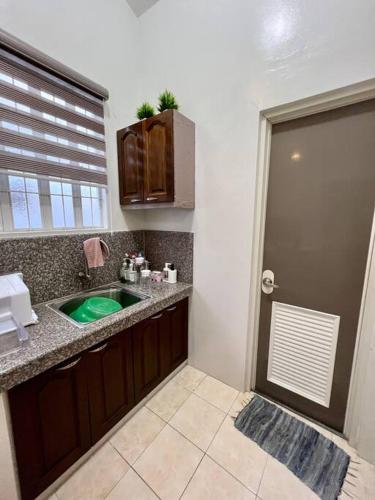 a bathroom with a green sink and a window at Spacious & Cozy 3BR House w/WIFI 