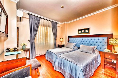 Letto o letti in una camera di Hotel Daphne