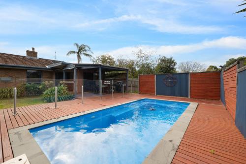 a swimming pool in the backyard of a house at Redwood Beach House in Cowes