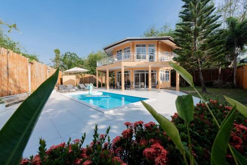 a house with a swimming pool in the backyard at Twin Villas Ao Nang in Ao Nang Beach
