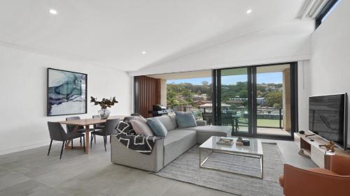 a living room with a couch and a table at #8 The Ash Apartments Close To Beach Accom Holidays in Terrigal