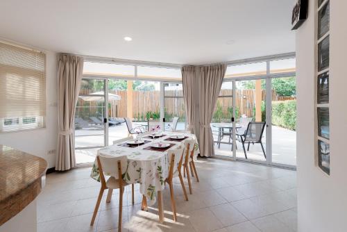 a dining room with a table and a large window at Twin Villas Ao Nang in Ao Nang Beach
